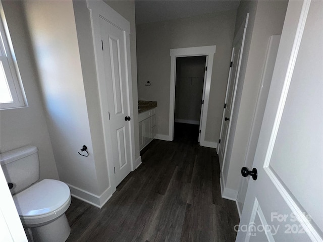 bathroom with hardwood / wood-style floors, vanity, and toilet