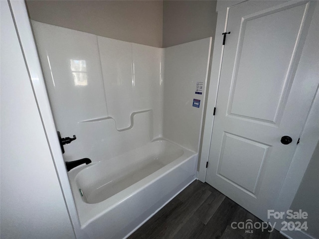 bathroom featuring wood-type flooring and tub / shower combination