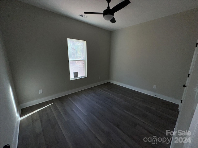 spare room featuring ceiling fan and dark hardwood / wood-style floors