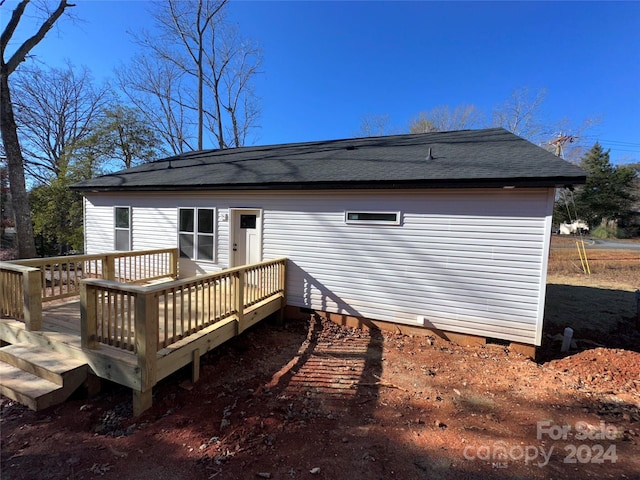 back of property with a wooden deck