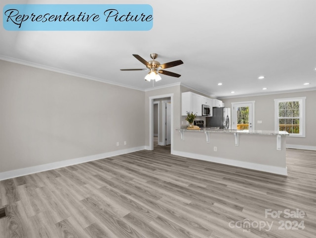 unfurnished living room with crown molding, ceiling fan, and light hardwood / wood-style flooring