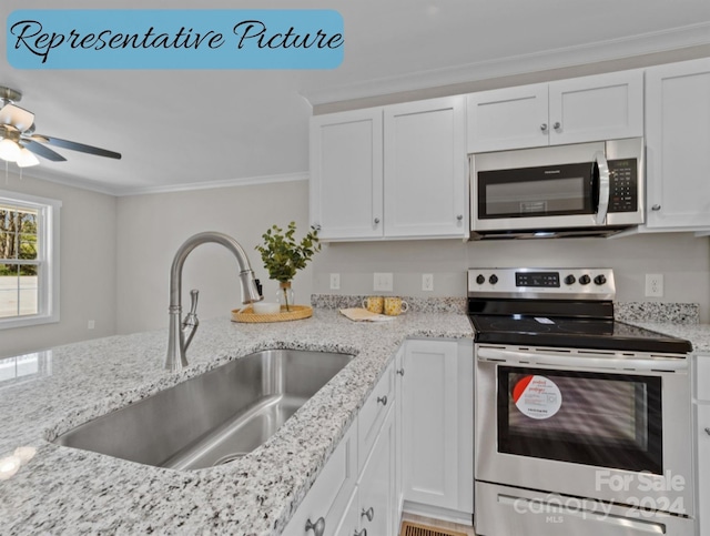 kitchen featuring light stone counters, sink, white cabinetry, appliances with stainless steel finishes, and crown molding