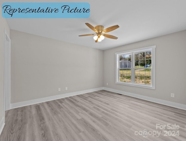 spare room featuring ceiling fan and light hardwood / wood-style flooring