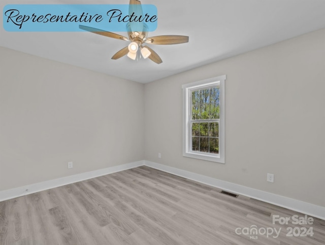 empty room with light wood-type flooring and ceiling fan