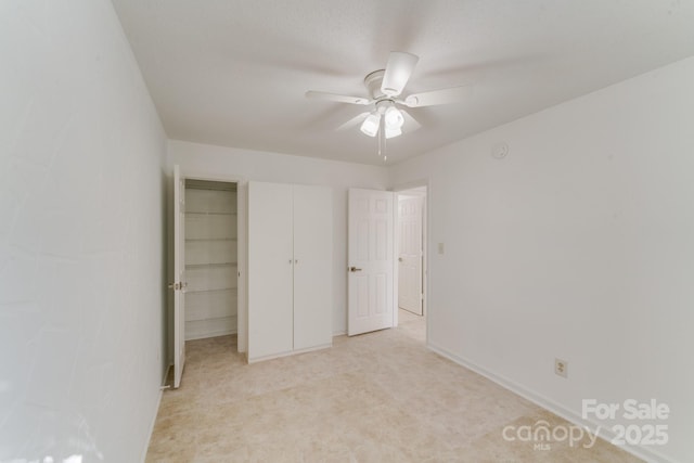 unfurnished bedroom with light carpet and ceiling fan