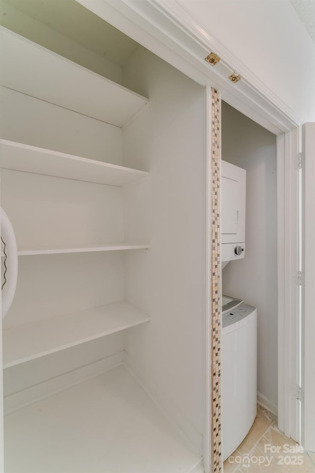 closet with stacked washer and clothes dryer