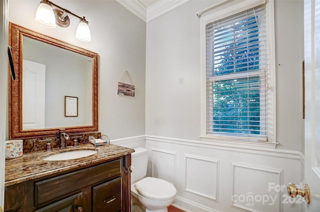 bathroom featuring ornamental molding, vanity, and toilet