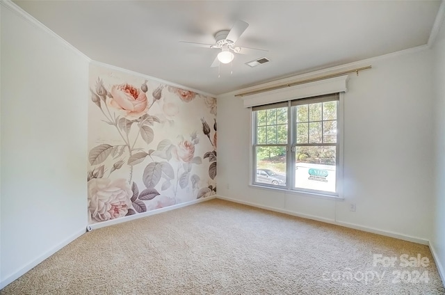 unfurnished room featuring carpet floors, ornamental molding, and ceiling fan