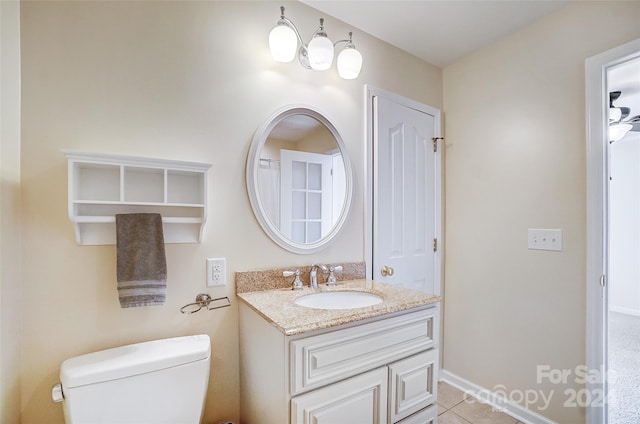 bathroom with vanity, tile patterned flooring, and toilet