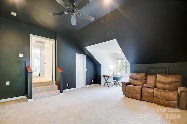 interior space featuring ceiling fan, light colored carpet, and lofted ceiling