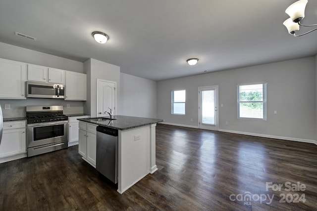 kitchen featuring stainless steel appliances, dark wood-type flooring, and white cabinetry