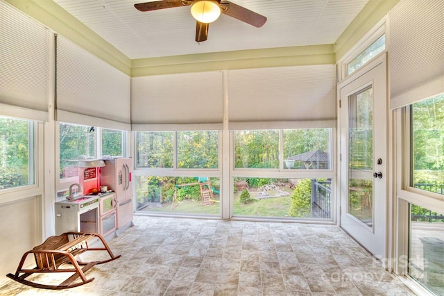 unfurnished sunroom with plenty of natural light and ceiling fan