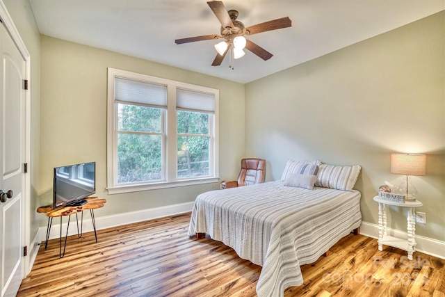 bedroom with light hardwood / wood-style floors and ceiling fan