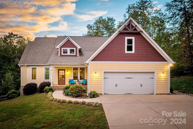 craftsman-style home with a porch and a yard