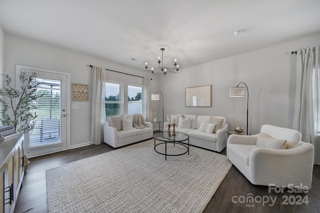 living room featuring a notable chandelier and dark hardwood / wood-style floors