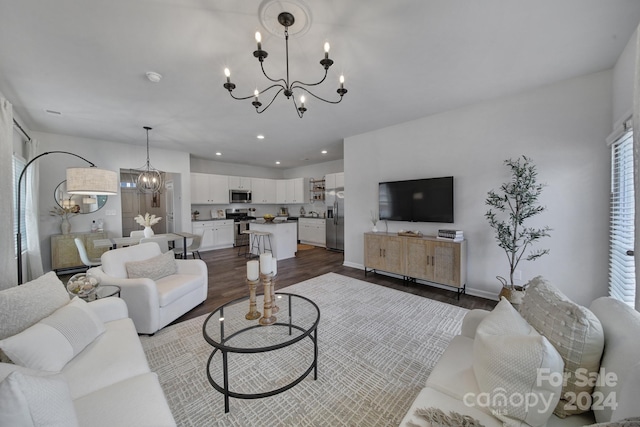 living room with wood-type flooring and an inviting chandelier