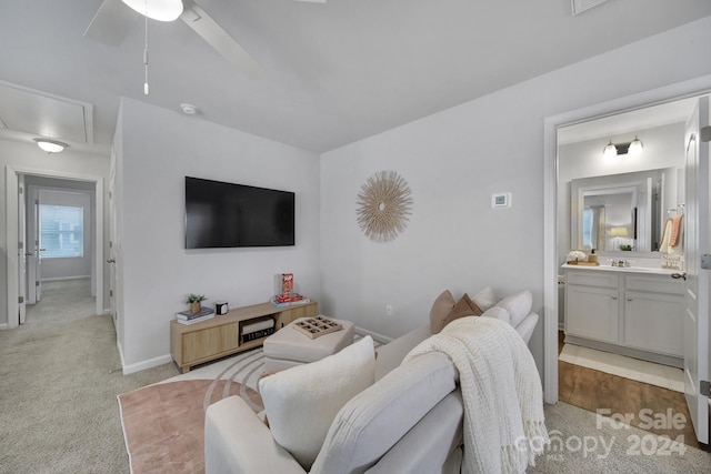 living room with light colored carpet and ceiling fan