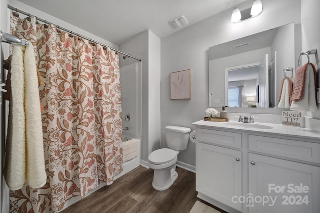 full bathroom featuring vanity, hardwood / wood-style floors, toilet, and shower / bathtub combination with curtain