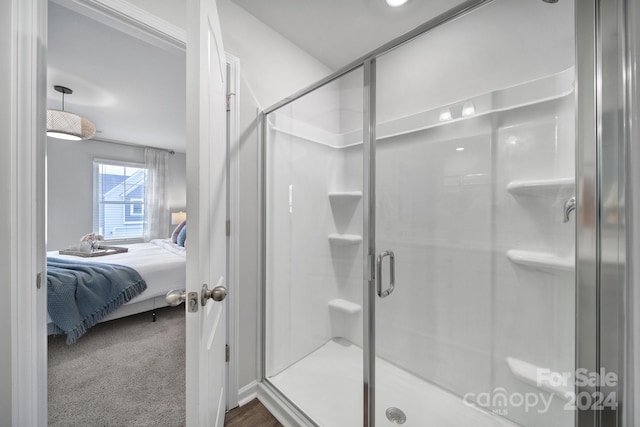 bathroom featuring a shower with shower door