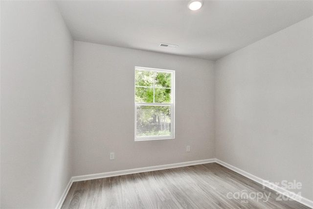 spare room with hardwood / wood-style floors