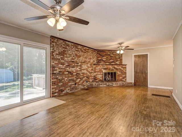 unfurnished living room featuring ceiling fan, a textured ceiling, and brick wall