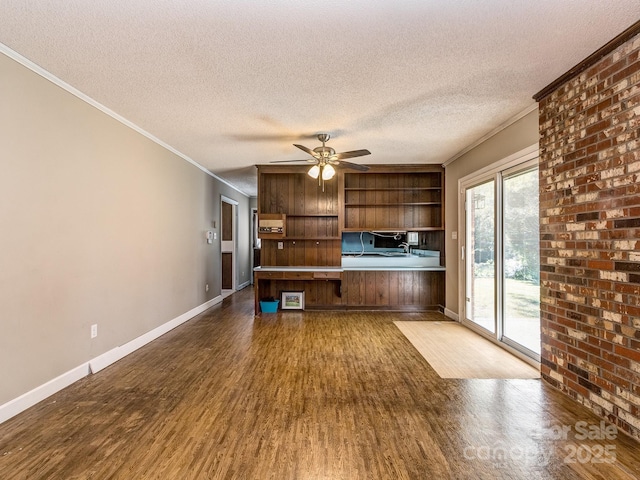 unfurnished living room with dark hardwood / wood-style flooring, a textured ceiling, ceiling fan, and crown molding