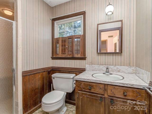 bathroom with vanity, toilet, and an enclosed shower