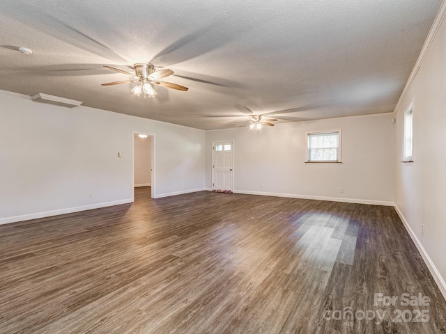 spare room featuring crown molding, dark hardwood / wood-style flooring, ceiling fan, and a textured ceiling