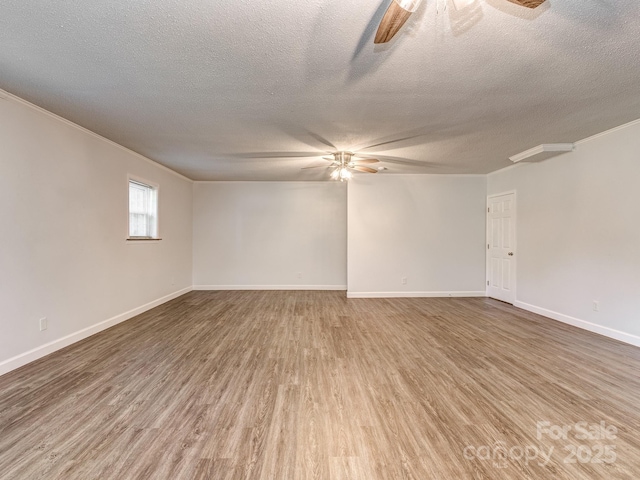 spare room featuring ornamental molding, a textured ceiling, and hardwood / wood-style flooring