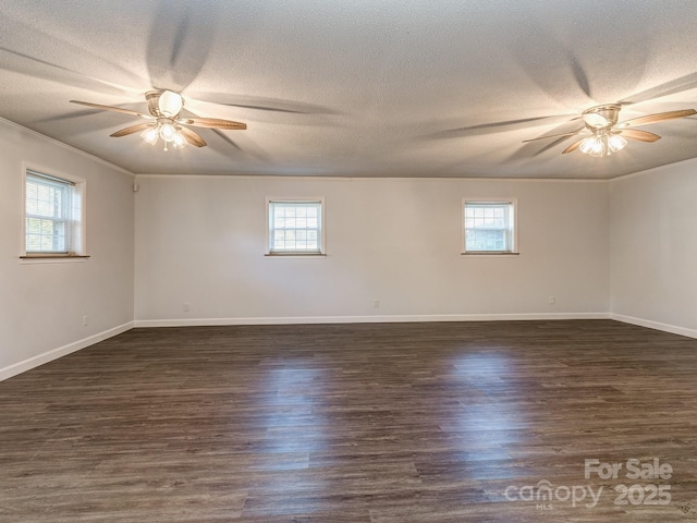 spare room with ornamental molding, a textured ceiling, ceiling fan, and dark wood-type flooring