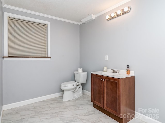 bathroom with vanity, ornamental molding, a textured ceiling, and toilet