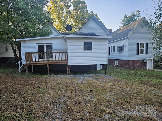 rear view of house featuring a yard, a wooden deck, and central AC