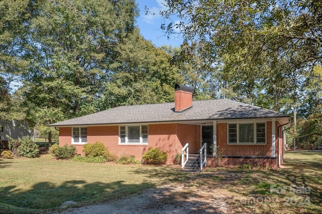 ranch-style house with a front lawn