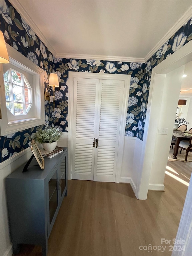 entryway featuring hardwood / wood-style flooring and crown molding