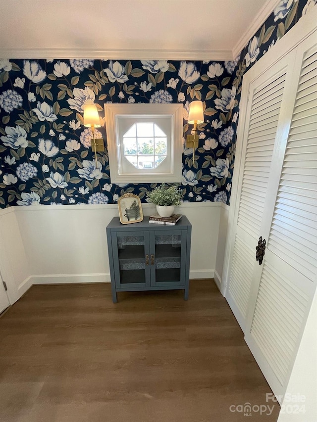 hallway featuring ornamental molding and dark hardwood / wood-style flooring