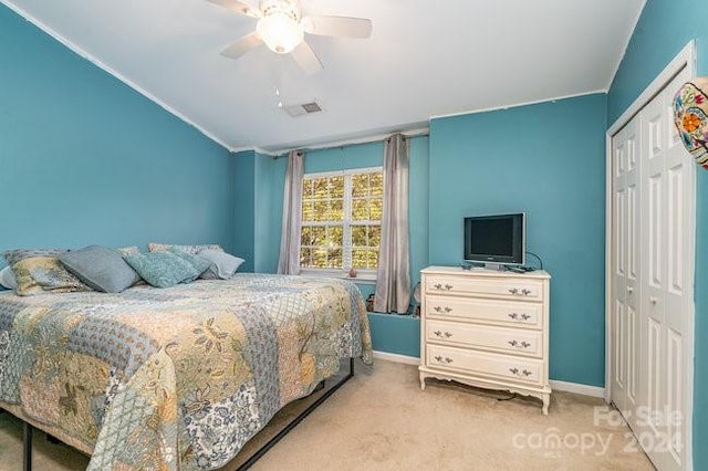 carpeted bedroom featuring a closet and ceiling fan