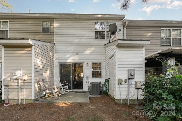 back of property featuring cooling unit and a patio