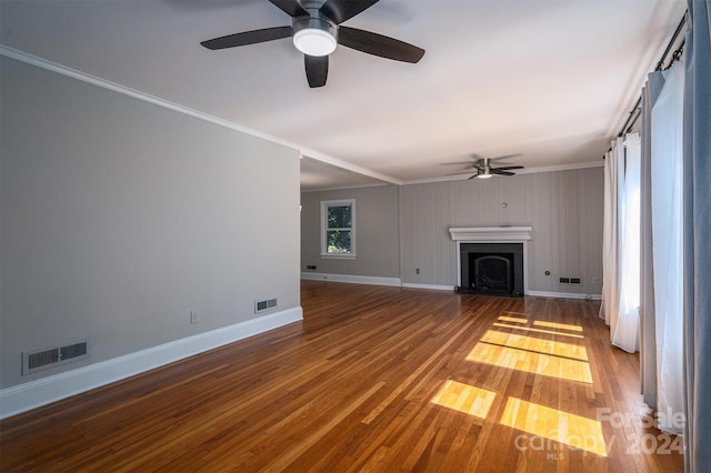 unfurnished living room with ceiling fan, hardwood / wood-style flooring, and crown molding