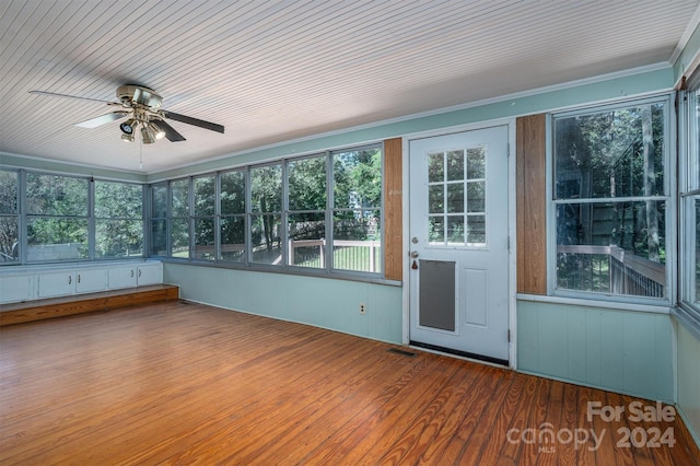 unfurnished sunroom with ceiling fan