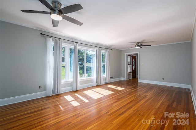 empty room with crown molding, ceiling fan, and hardwood / wood-style floors