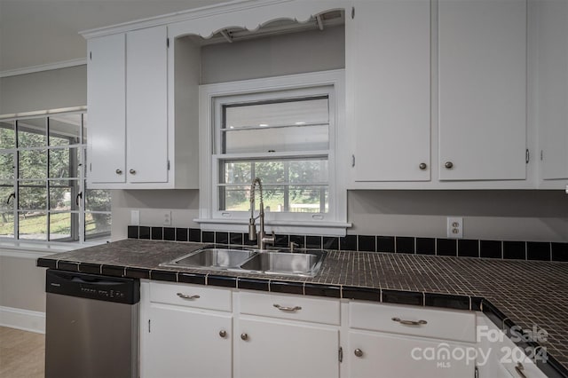 kitchen with sink, a healthy amount of sunlight, stainless steel dishwasher, and white cabinets