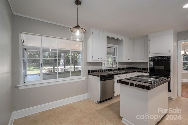 kitchen featuring black oven, decorative light fixtures, sink, white cabinets, and stainless steel dishwasher