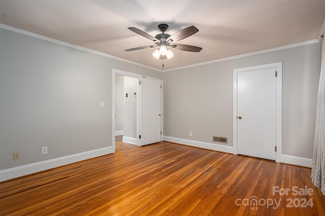 unfurnished bedroom with wood-type flooring, crown molding, and ceiling fan