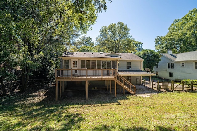 back of property featuring a yard and a deck