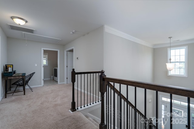 hallway with light colored carpet and crown molding