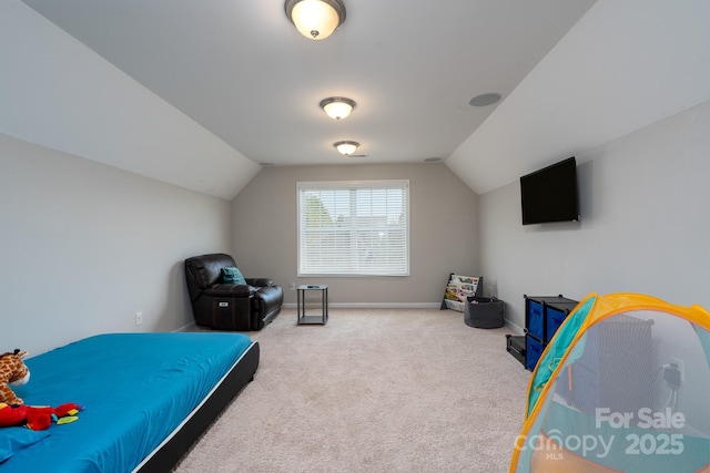 bedroom with lofted ceiling and carpet floors