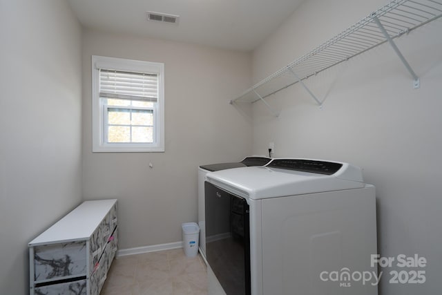 clothes washing area with independent washer and dryer