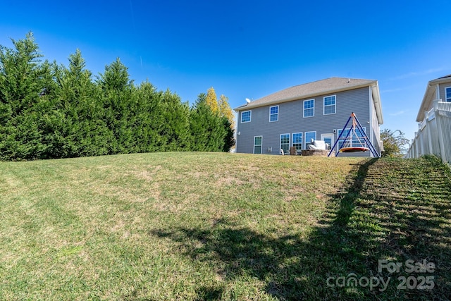 rear view of house with a yard