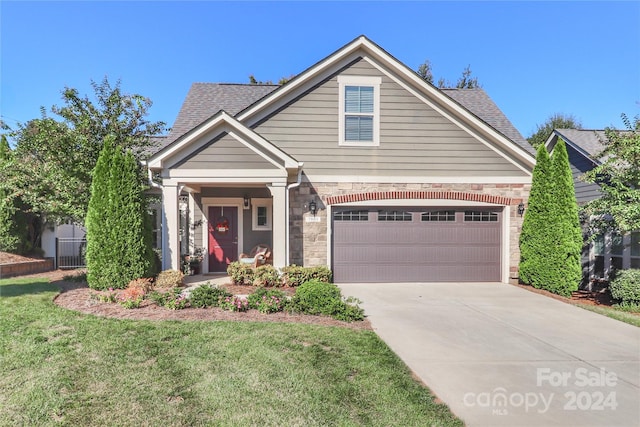 view of front of home with a garage and a front yard