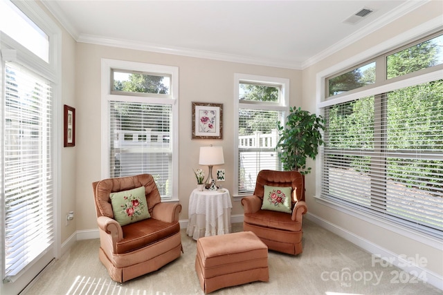 living area with plenty of natural light, crown molding, and light carpet